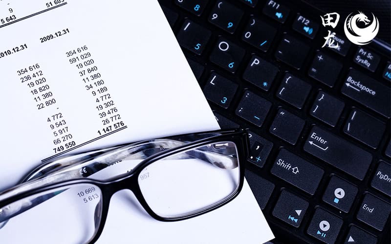 Spectacles resting on top of accounting paper